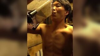 An Chinese man is guzzling a smoothie...