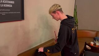 2 fellows poke and smooch in a public restroom in a cafe